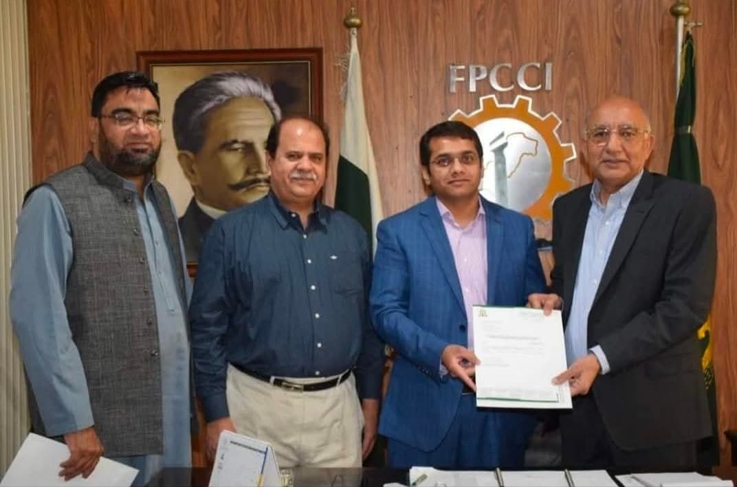 Muhammad Nadeem Qureshi presenting FPCCI Deputy Convener notification to Muhammad Shoaib Hassan at FPCCI Regional Office Lahore